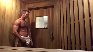 Handsome muscle guy jerks off in public sauna